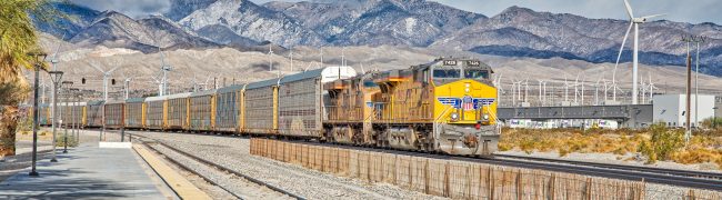 Palm Springs, California, USA - January 23, 2021: Union Pacific Freight train passing Palm Springs Amtrak Station (PSN).