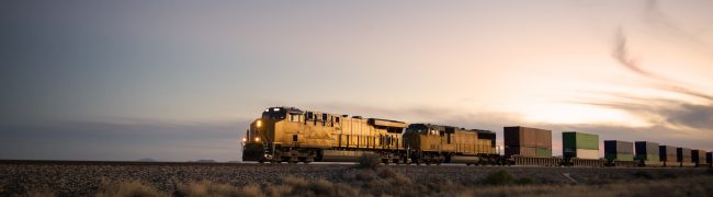 Cargo train travelling through desert.